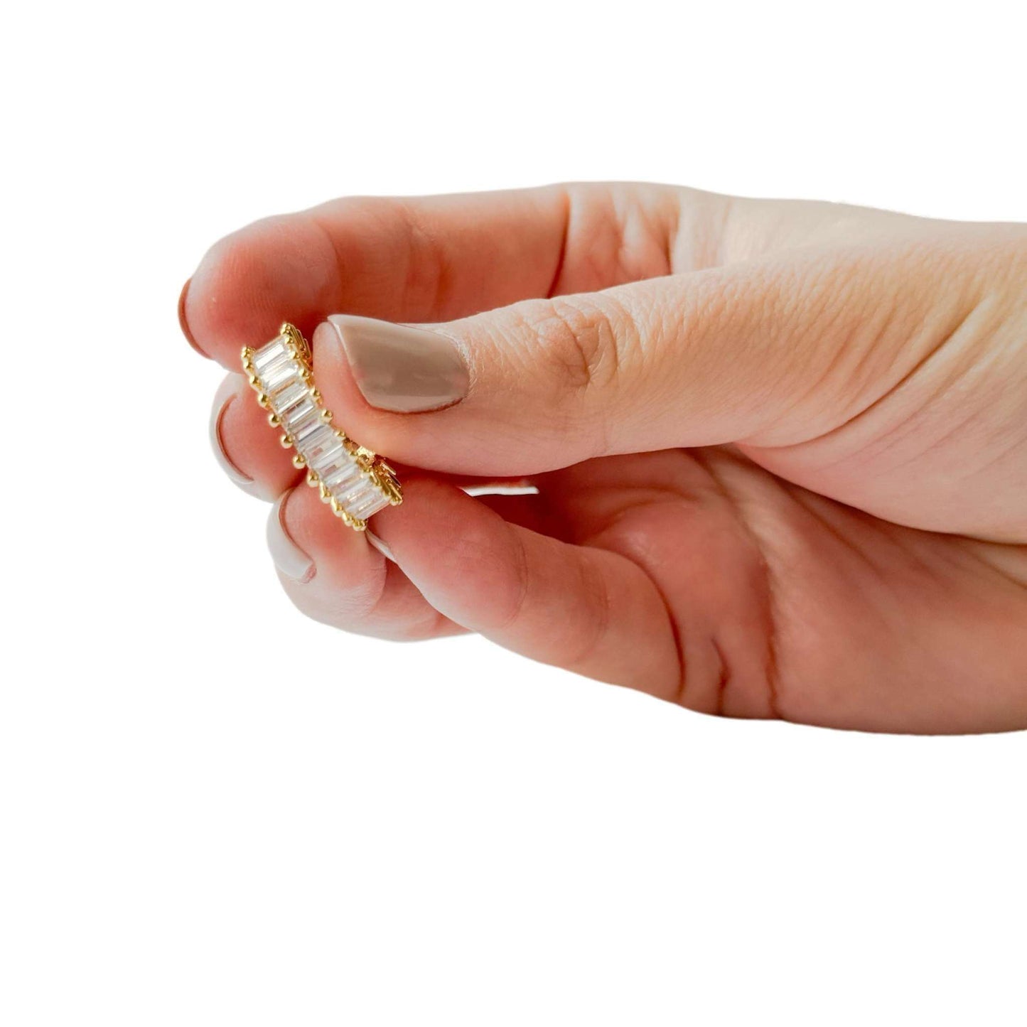 Amelia Cubic Zirconia Baguette Adjustable Ring held between fingers showcasing its elegant design.