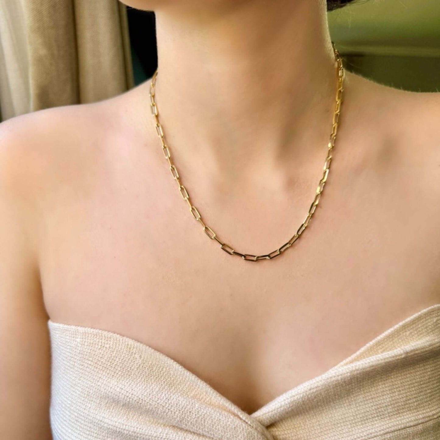 Belamy 18K Gold-Filled Paperclip Chain Necklace worn elegantly on a model's neck showcasing its sleek design.
