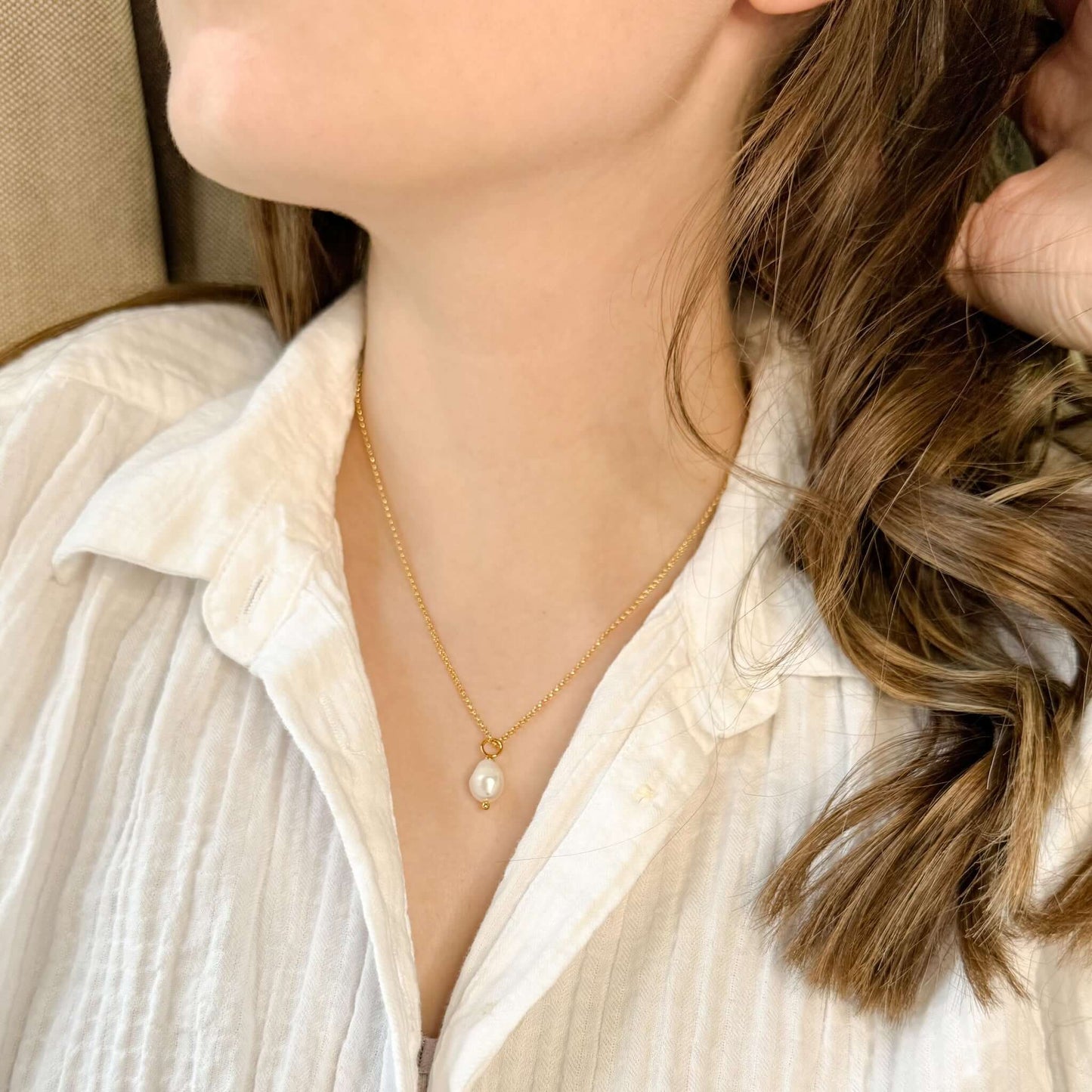 Briar Freshwater Pearl Gold Necklace worn by a woman, featuring a single pearl on a gold-filled chain.
