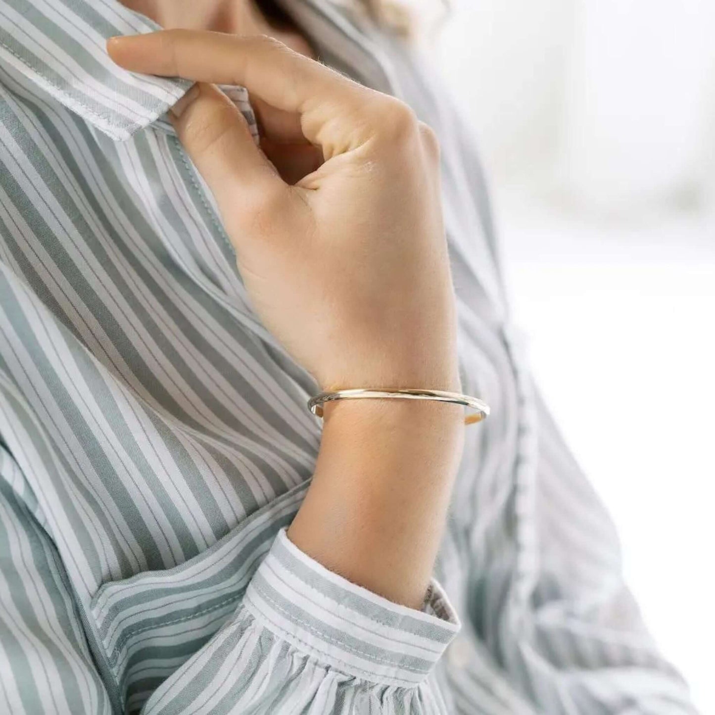 Elenora Classic Cuff Bracelet worn on a woman's wrist, featuring a sleek and minimal design.