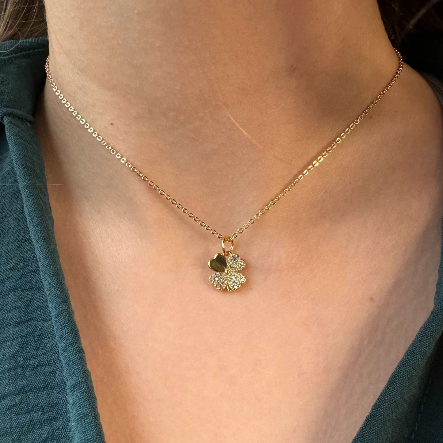 Leighton Gold Four Leaf Clover CZ Pendant Necklace worn on a model, showcasing the gold-plated pendant with cubic zirconia.