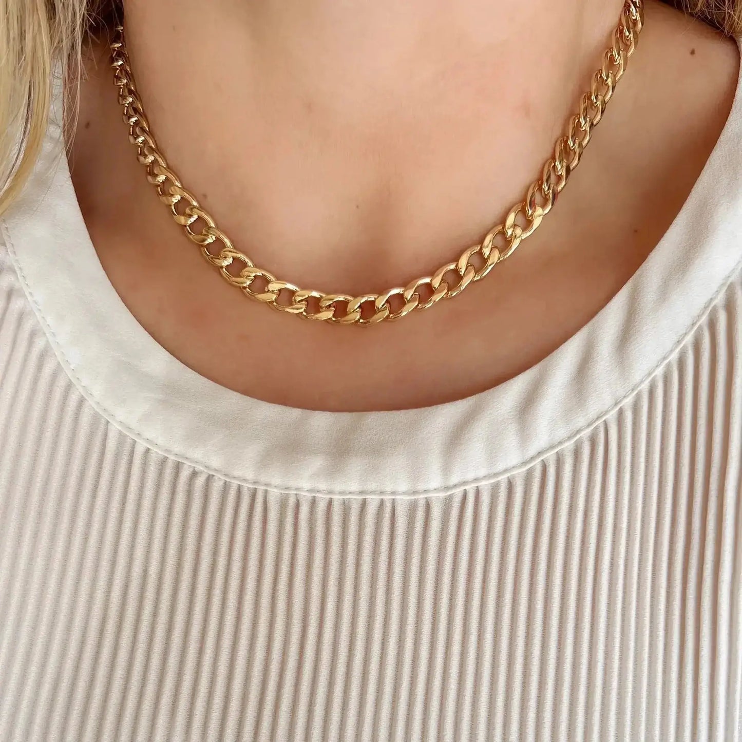 Lennon 18K Gold-Filled Cuban Chain Necklace worn on a model, showcasing its shine and collarbone length.
