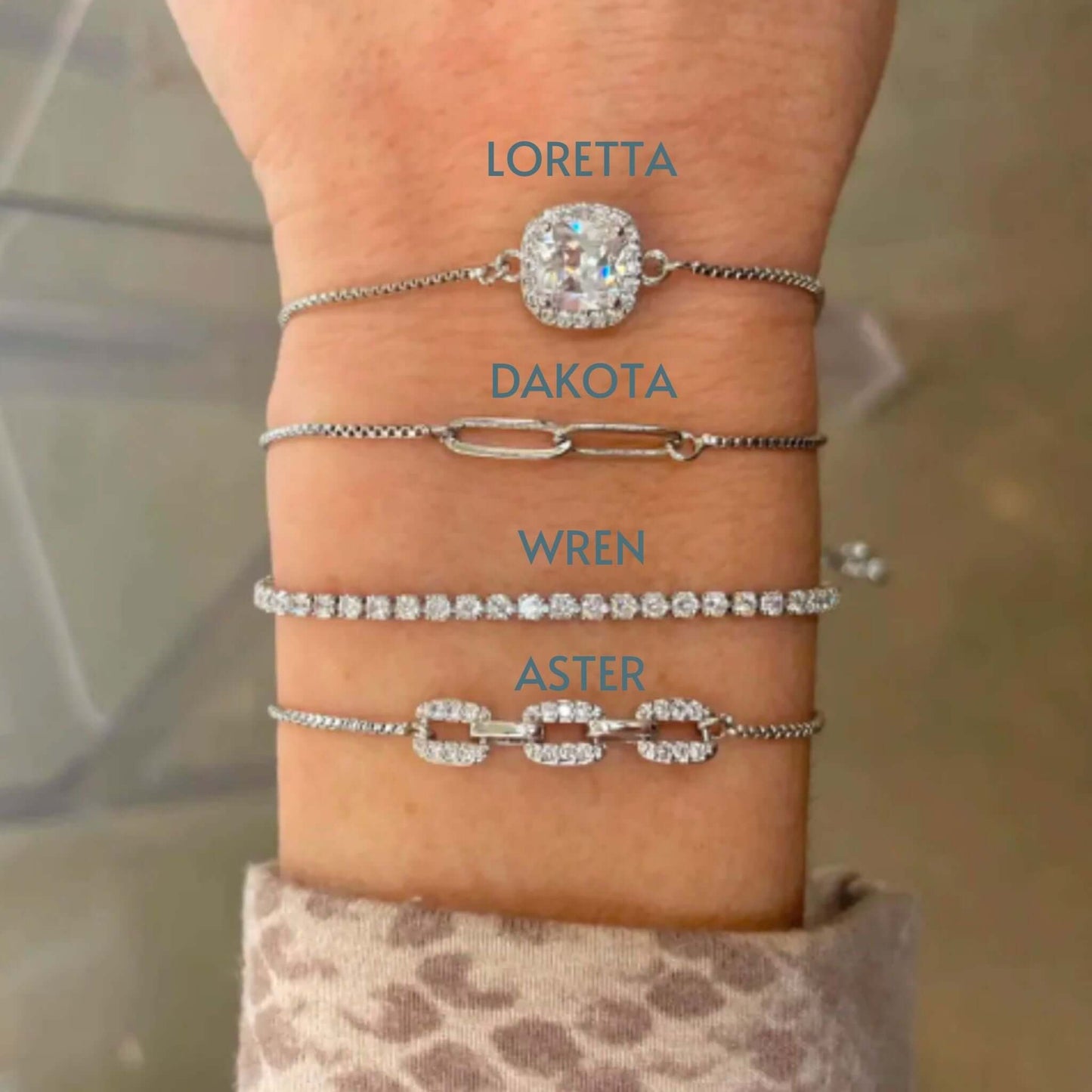 Loretta CZ Adjustable Sliding Bracelet showcased on a wrist among other stylish bracelets.