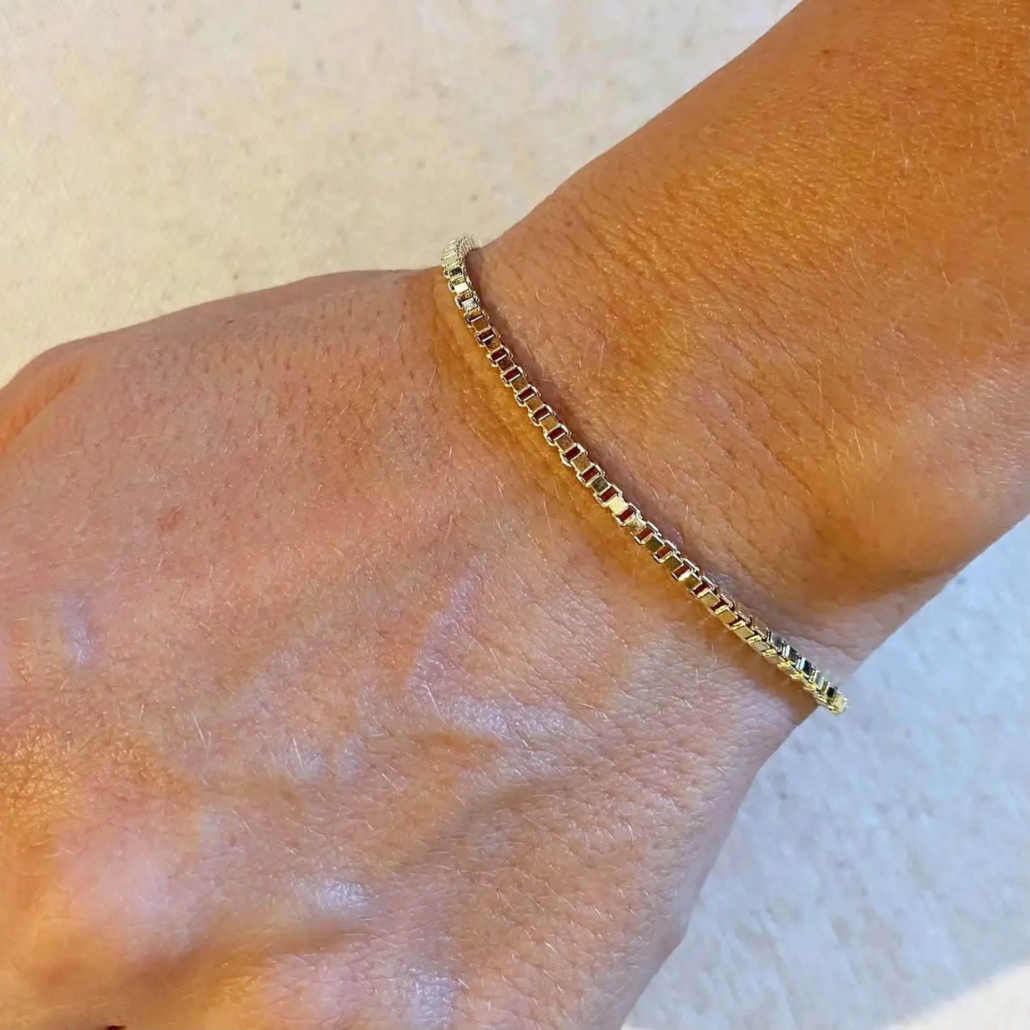 Mercer 18K Gold-Filled Box Chain Bracelet worn on wrist, showcasing its flat and minimal design.