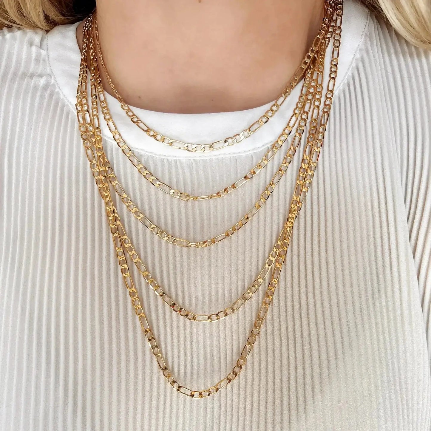 Parker 18K Gold-Filled Figaro Chain Necklace worn in layers on a model's neck, showcasing its elegant design.
