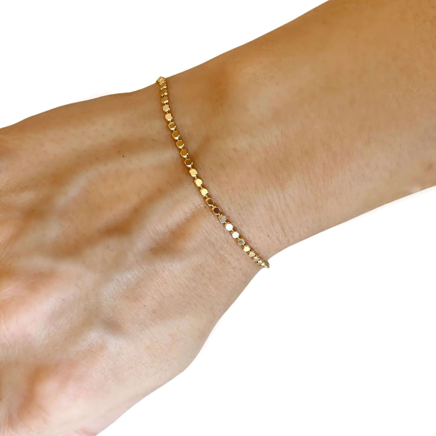 Piper 18K Gold-Filled Dainty Flat Ball Bracelet worn on a wrist, showcasing the textured flat disc beads.