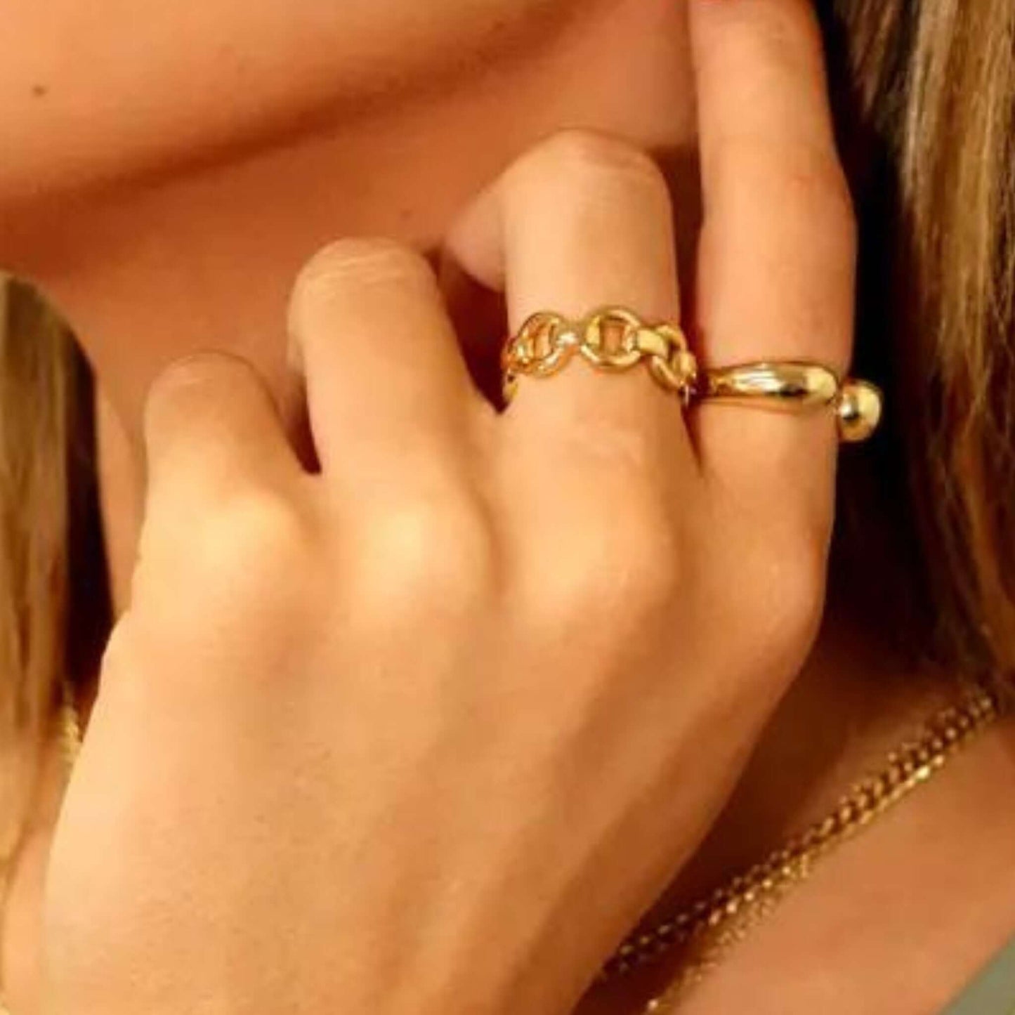 Model wearing the Presley Gold Chain Link Adjustable Ring alongside a sleek gold band ring.
