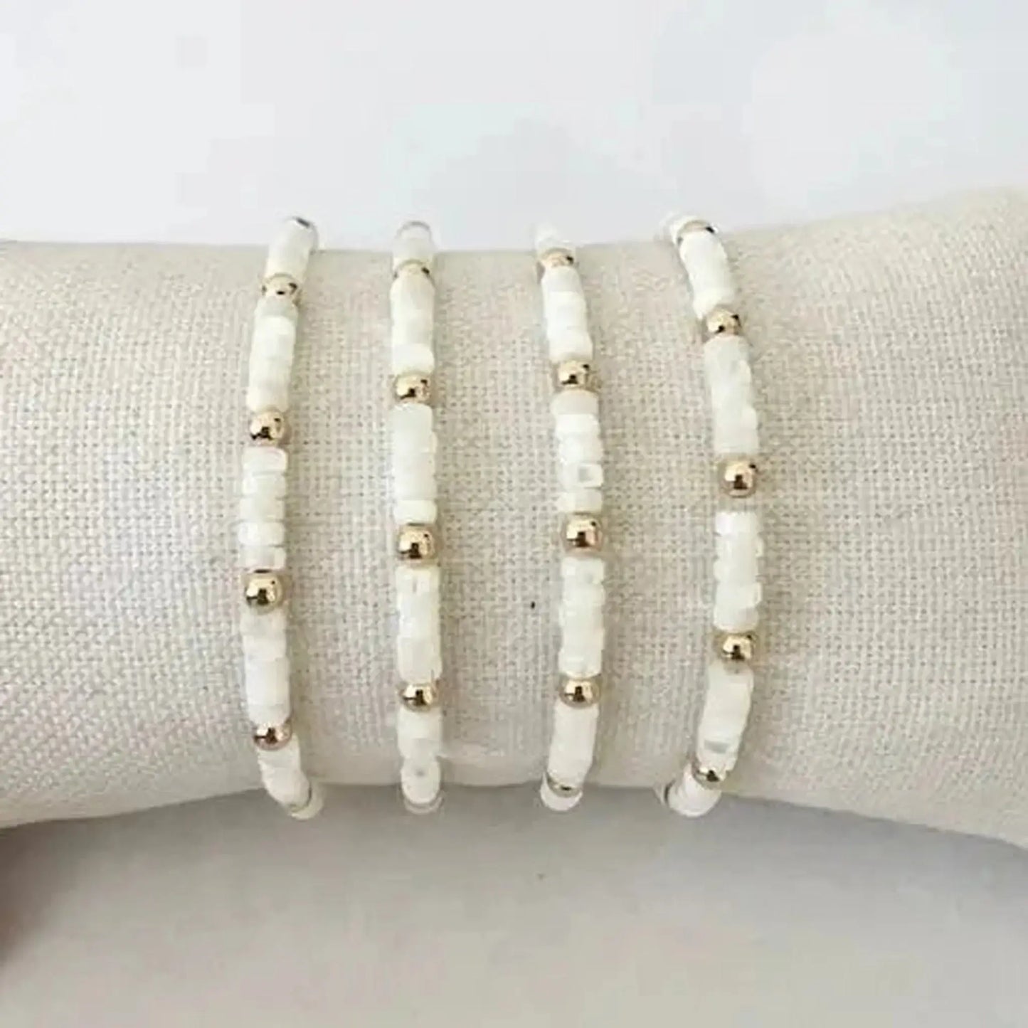 Rory Pearl & 14K Gold-Filled Stretch Bracelet displayed on a soft surface, featuring white shell and gold accents.