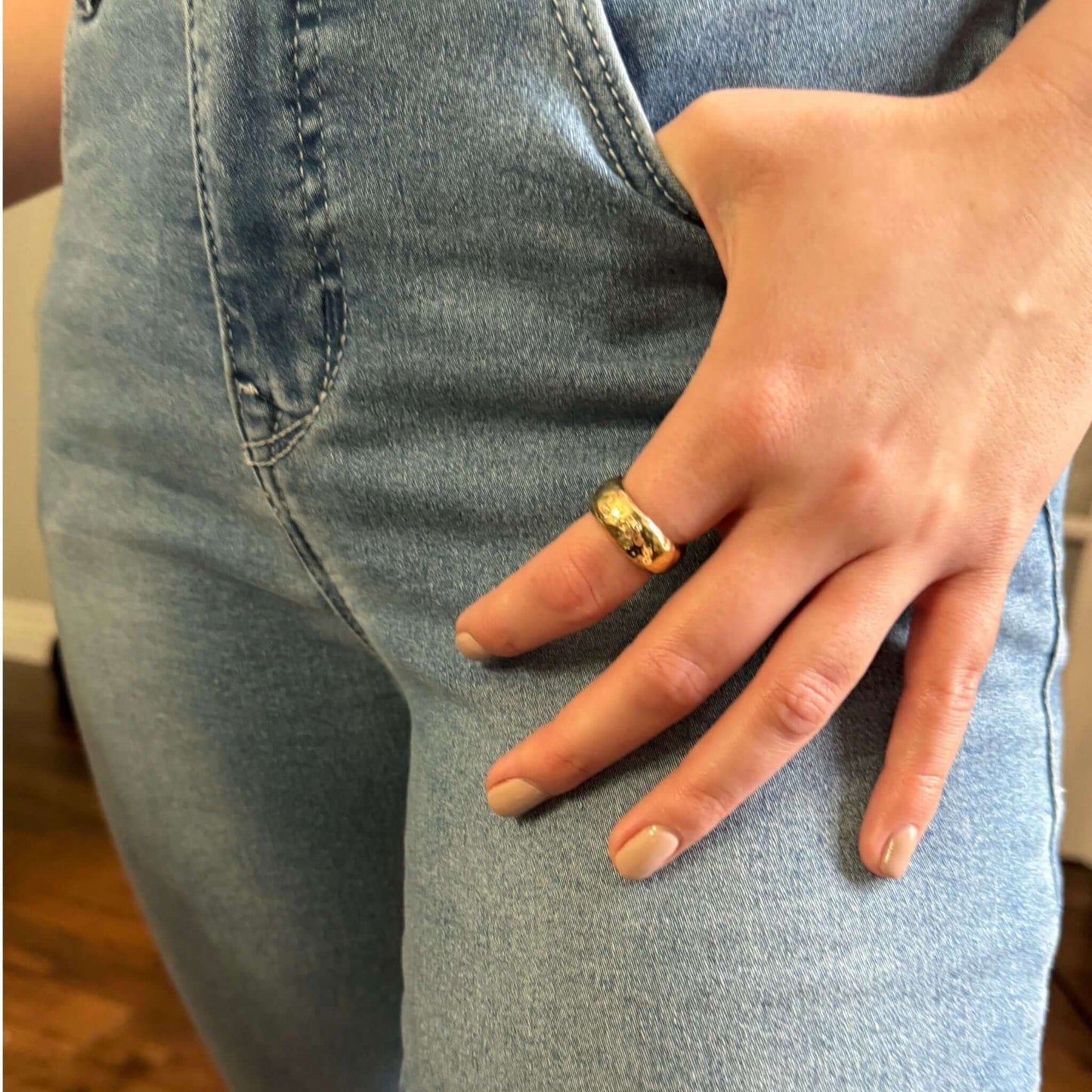 Samira Hammered Gold Adjustable Band worn on hand with trendy denim outfit, showcasing its chunky design.