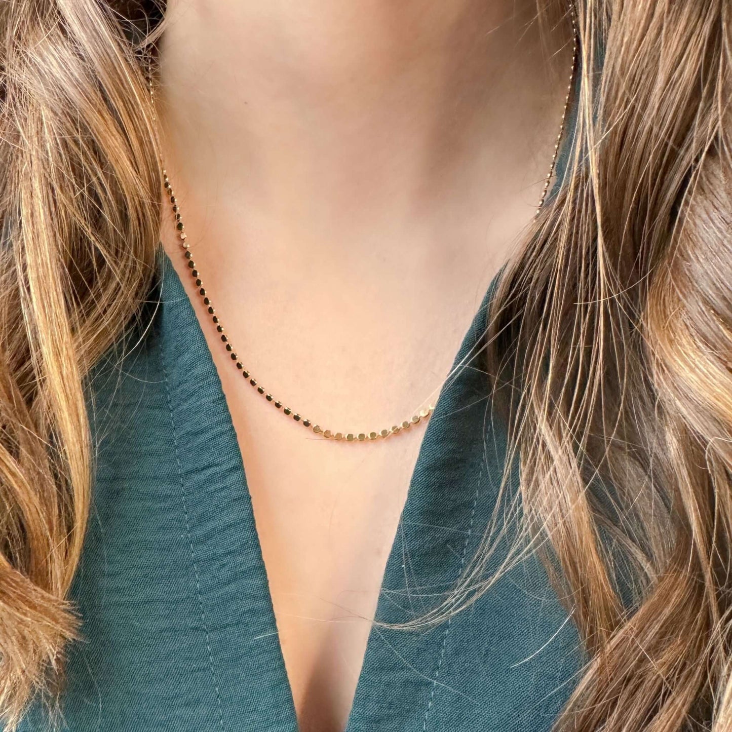 Sloane 18K Gold-Filled Flat Ball Necklace worn on a model, highlighting its delicate flat disc design.