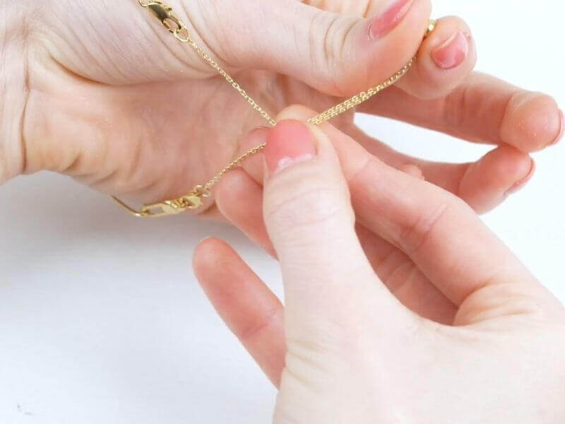 3" Claspable™ Adjustable Jewelry Clasp Converter Available in Gold and Silver being used to clasp a bracelet.